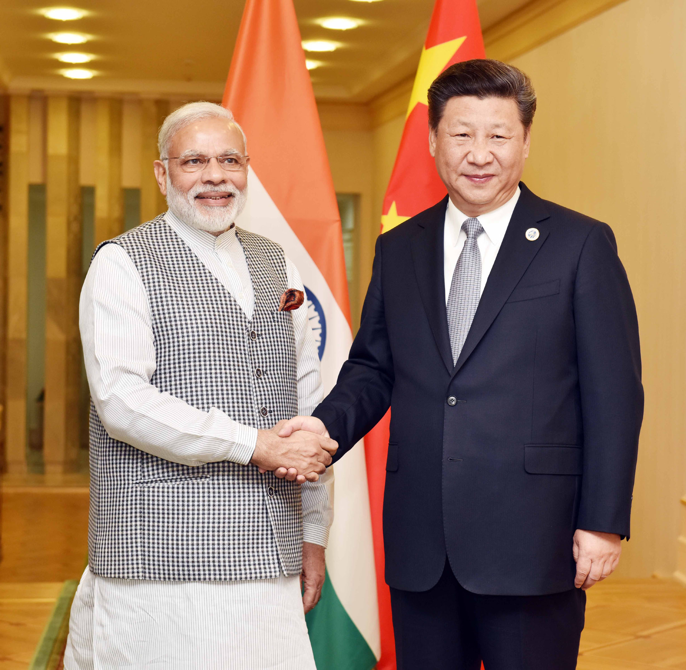 PM Modi and President Xi Jinping shake hands — India eases Chinese FDI restrictions after 6 years